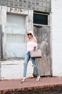 OTS Knit sweater, light beige leather satchel, distressed denim under $100