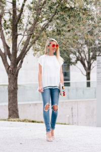 pom pom top under $100, summer pom pom blouse, distressed skinny blue jeans, beaded statement earrings, colorful embroidered oversized clutch