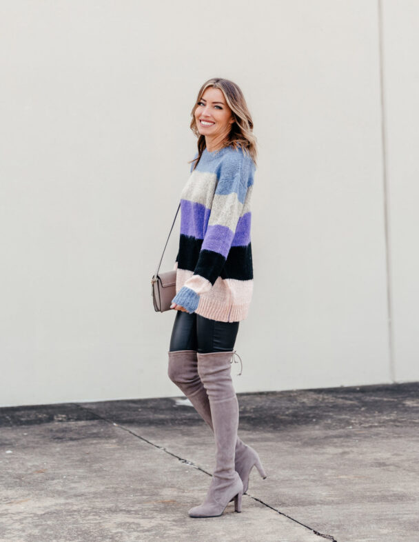 Colorblock sweater paired with faux leather leggings and OTK boots