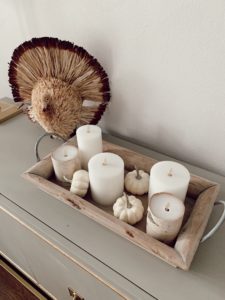lifestyle blogger sharing fall home decor candle arrangement