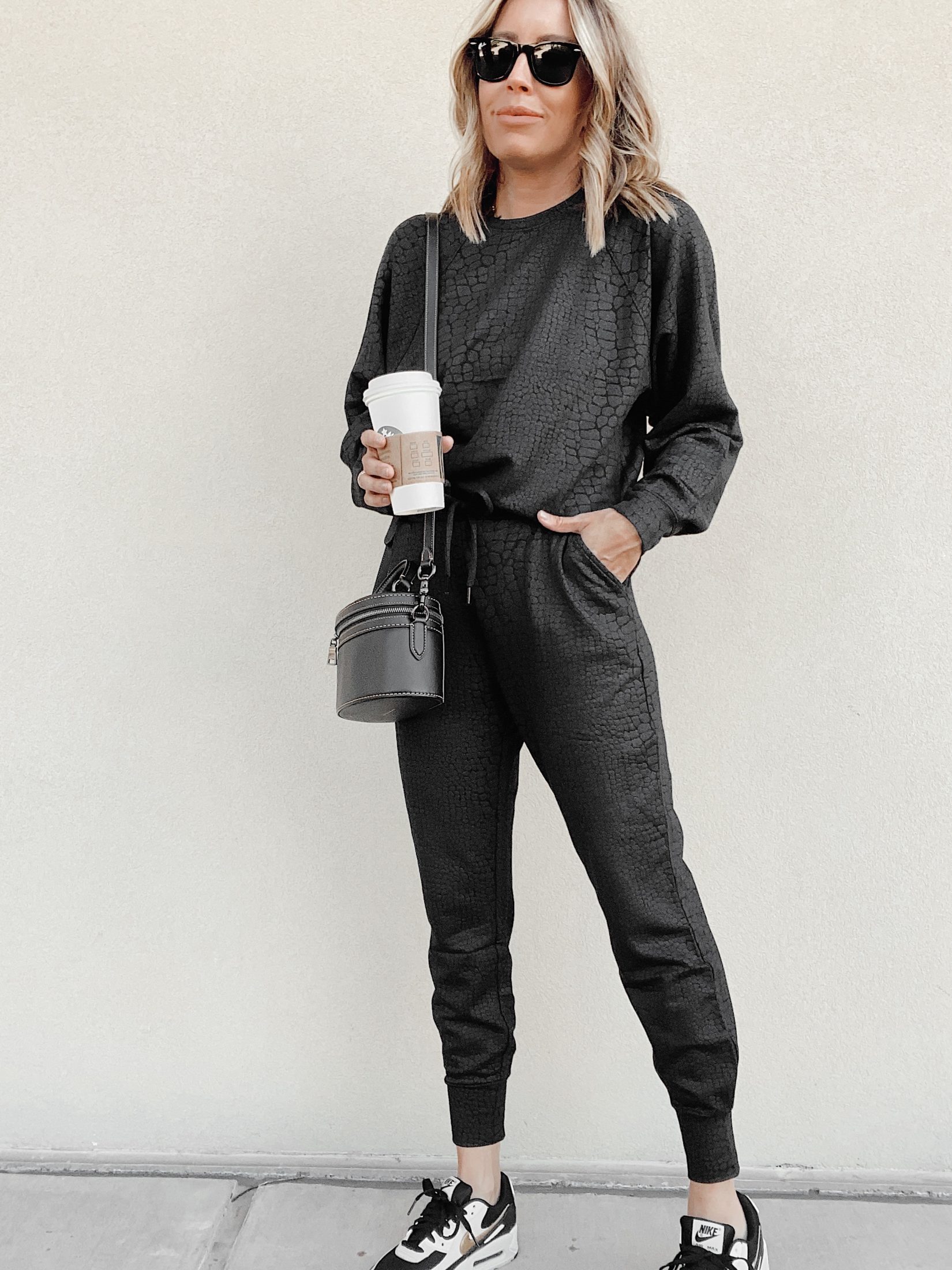 jaime shrayber wearing matching black croc embossed jogger loungewear set